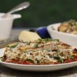 stuffed chicken breast oozing with sausage and cheese and topped with fresh parmesan and basil