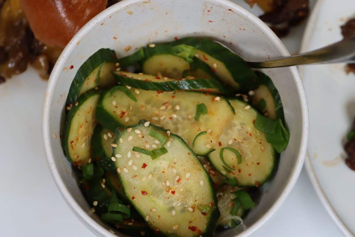 bowl of spicy Korean cucumbers - serve extras on the side with your sandwiches