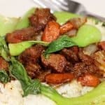 closer looks at plate of pork but stir fry with carrots and bok choy