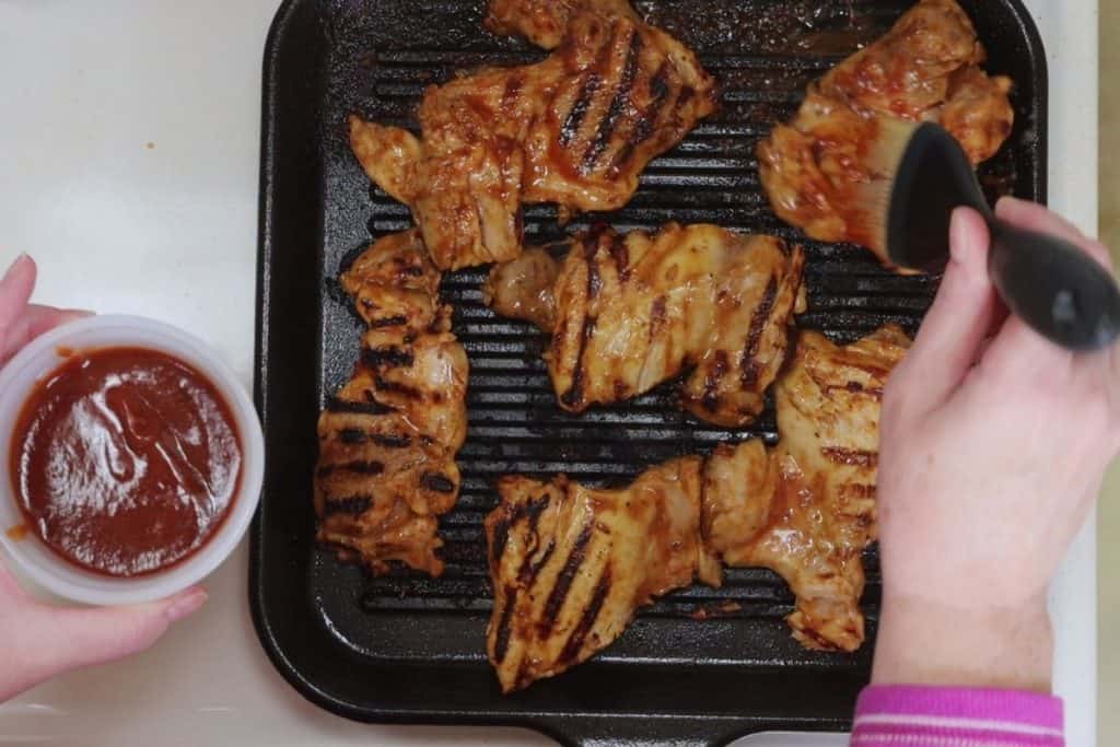 grill bbq chicken thighs grilling on a cast iron grill skillet