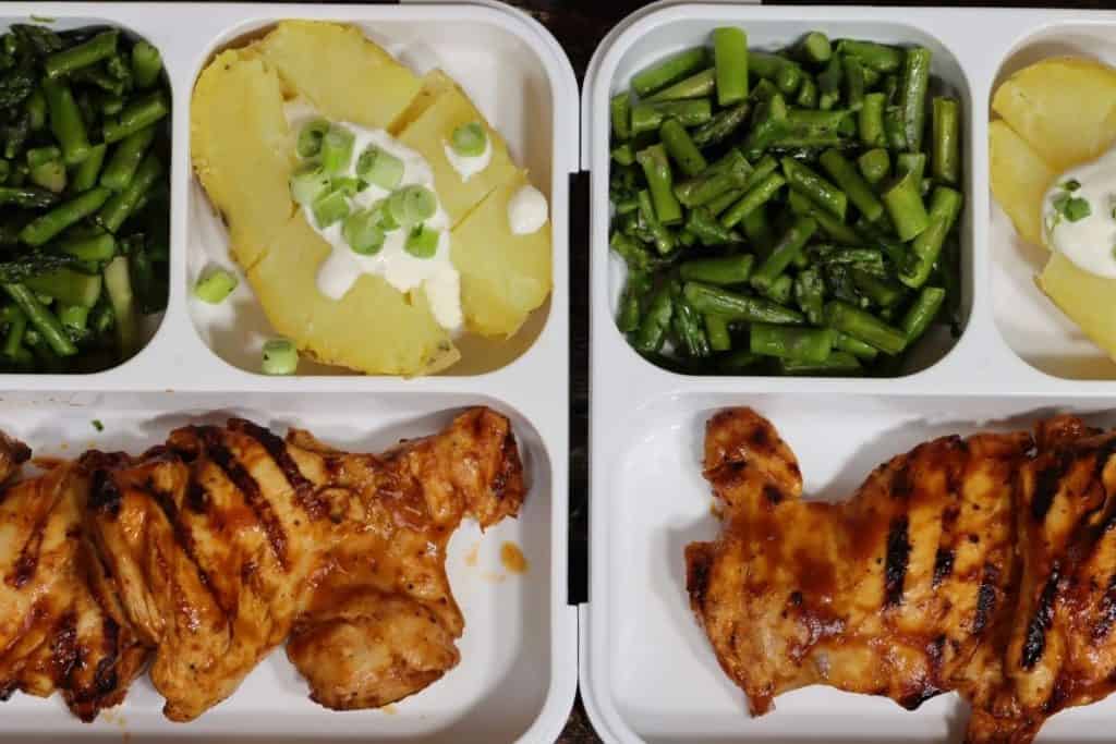 closer look at two meal prep bento boxes easy meal prep - four bento boxes with close up look at one bento box with Grilled BBQ chicken thighs with potato & asparagus