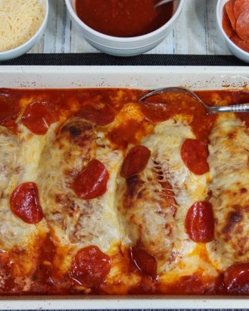 ready to serve on the dinner table: stuffed chicken pepperoni pizza bake
