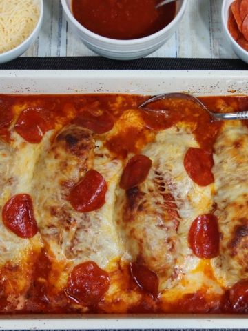ready to serve on the dinner table: stuffed chicken pepperoni pizza bake