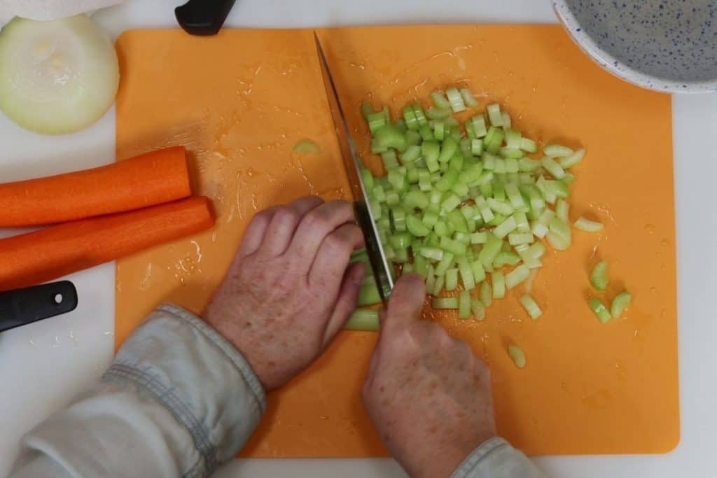chopping the mirepoix for one-pot chicken and dumplings