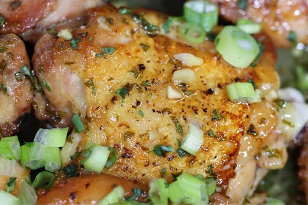 very close look at one piece of crispy chicken thighs with honey garlic sauce
