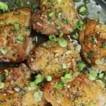 platter of crispy chicken thighs with honey garlic sauce
