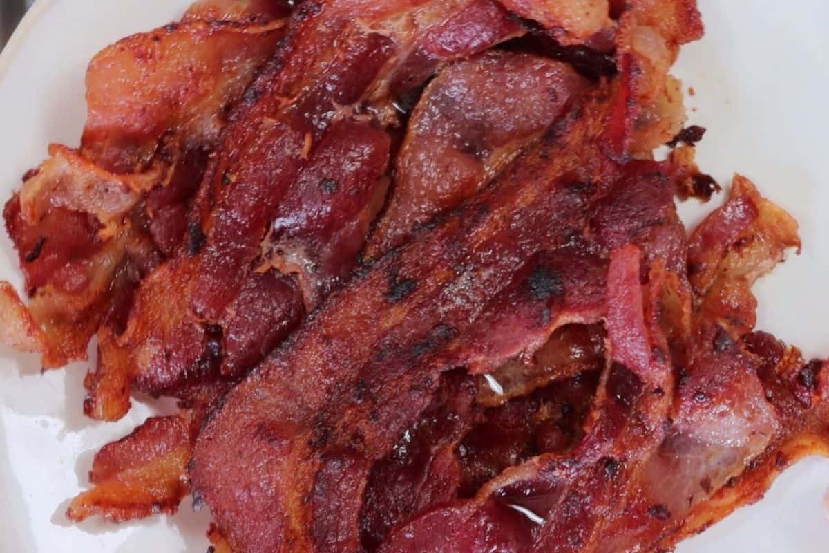 a plate of cooked bacon for the kackle burger chicken cutlet with bacon and cheese
