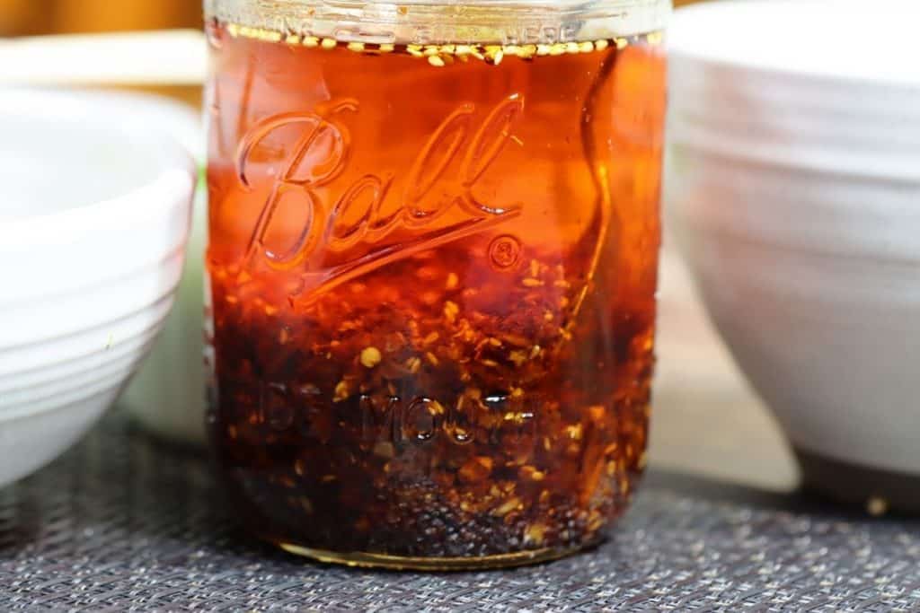 chili oil in a mason jar on a table
