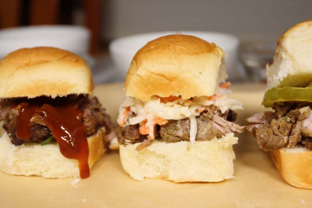 pork carnitas sliders three ways: with barbecue sauce, cole slaw and dill pickles