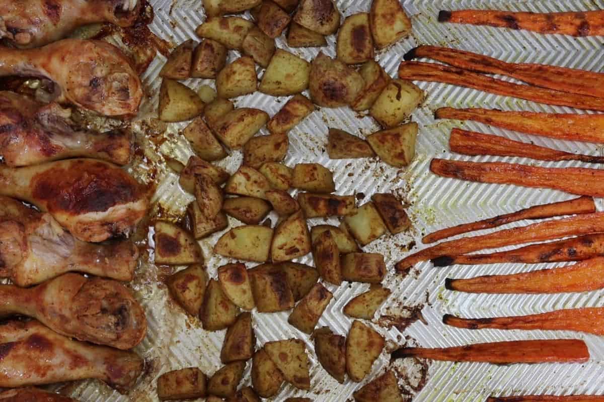easy sheet pan dinner with drumsticks, roasted carrots and cumin potatoes