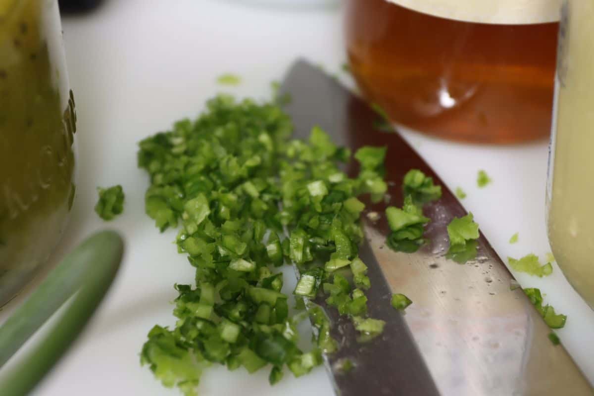 close up looks of finely diced garlic scapes for the vinaigrette