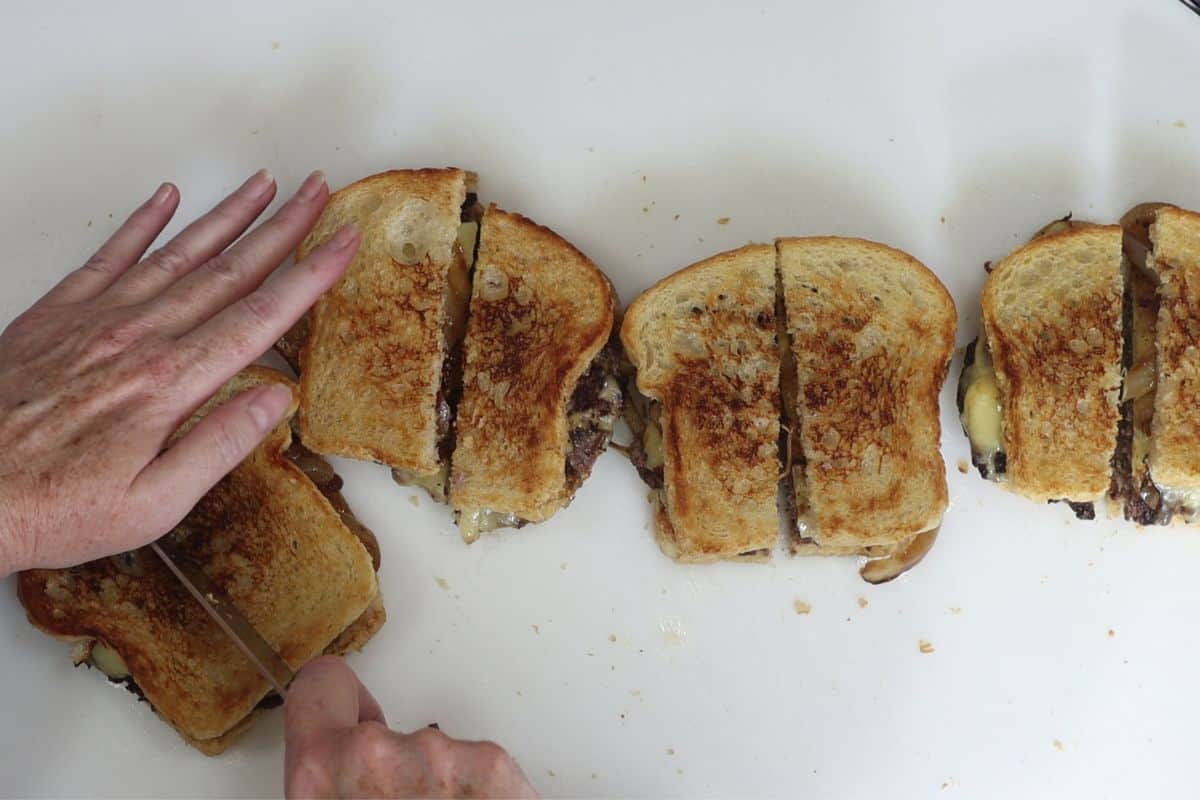 after your crunchy cheesy patty melts have been assembled, cut them in half and serve immediately