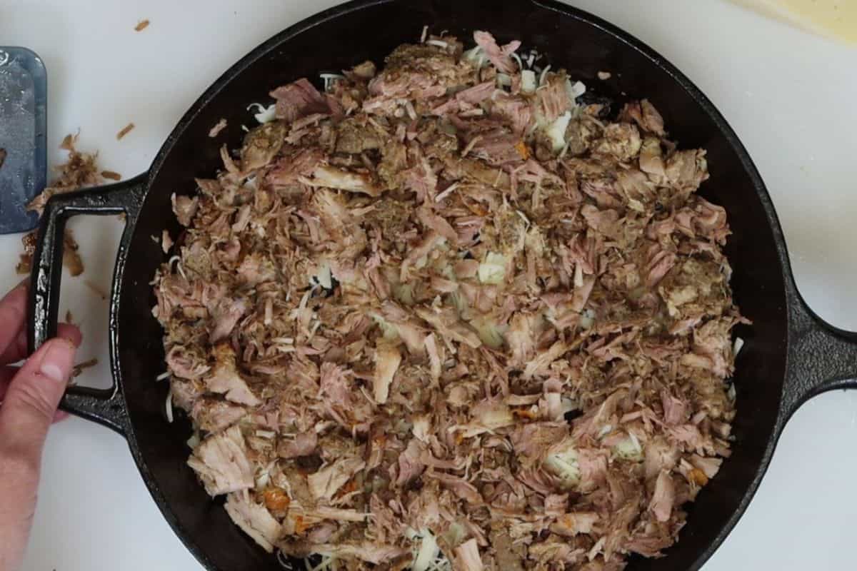 place the pork carnitas on top of the cheese