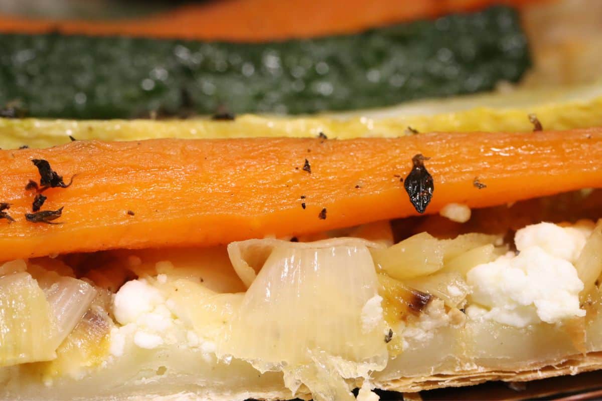 very close up side view of Roasted veggie tart with leeks and goat cheese