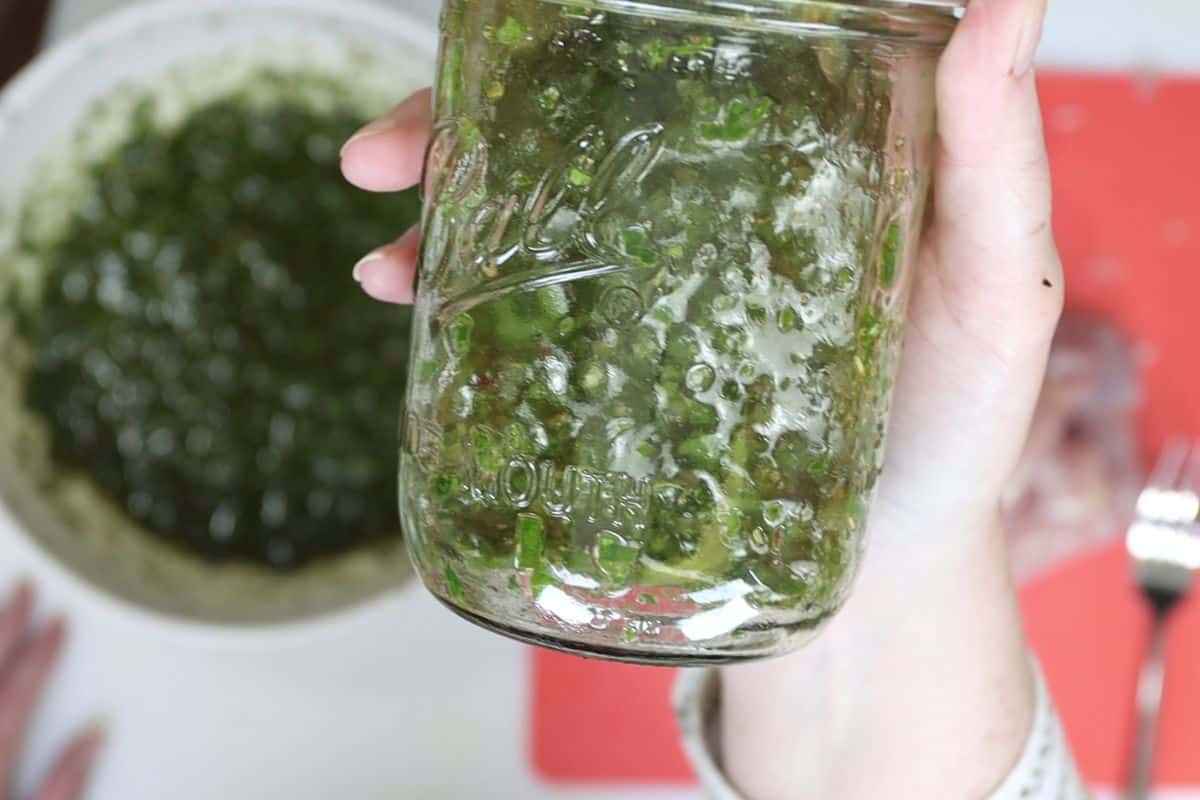 after mixing the chimichurri sauce set some aside in a jar or container to spoon over the chicken after it's cooked