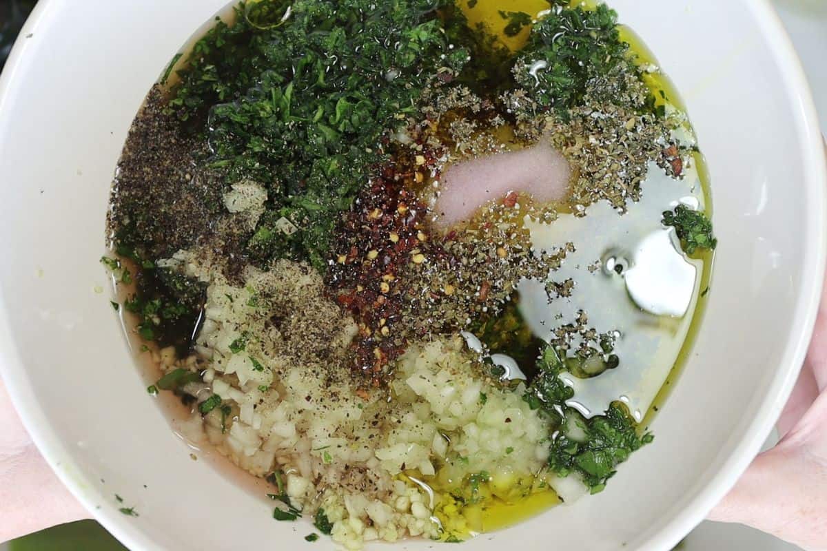 a look at the chimichurri sauce before mixing: a delicious blend of parsley, cilantro, garlic, onion, oregano, red wine vinegar and olive oil