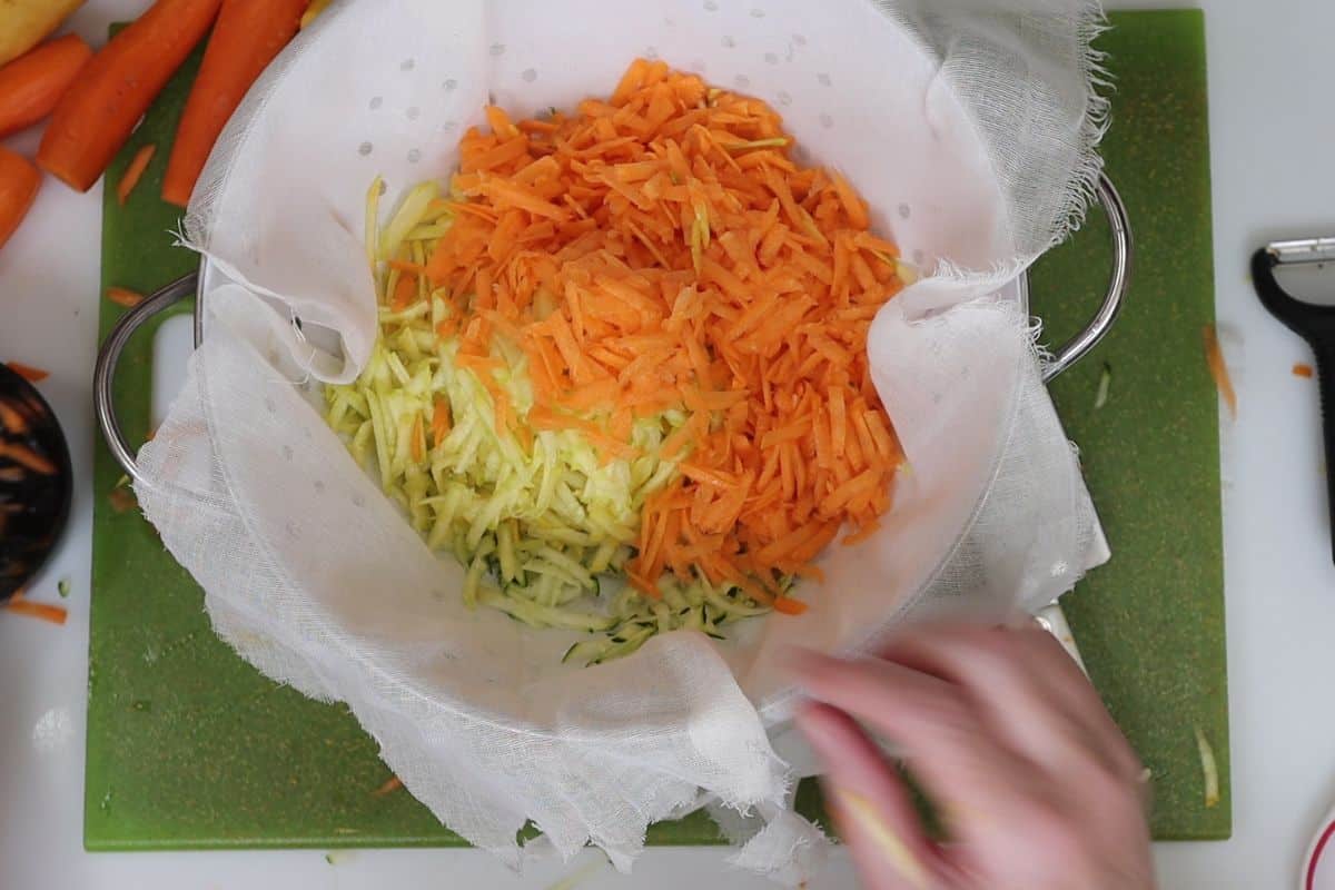1-steps to making chickpea veggie burgers-shred veggies put in cheesecloth lined colander
