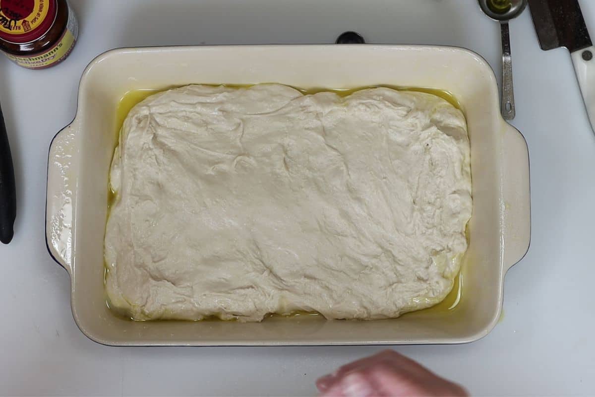 8-steps to making focaccia bread-gently press dough to edges like this