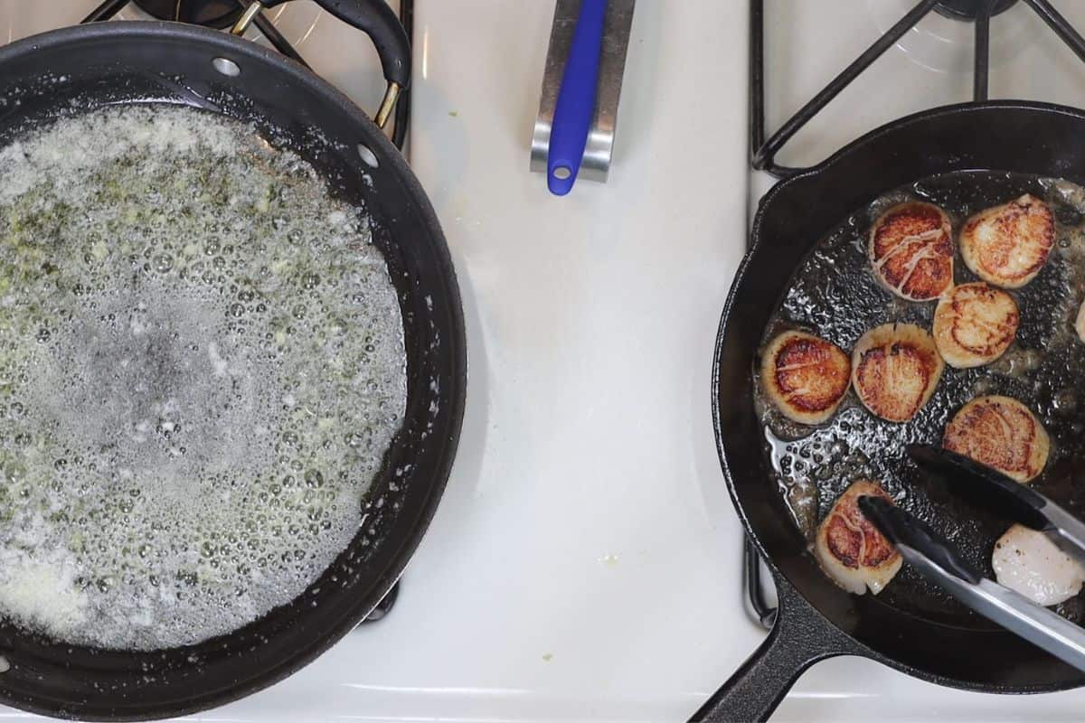 start searing the sea scallops in butter and canola oil (right) and cook butter for sauce (left)