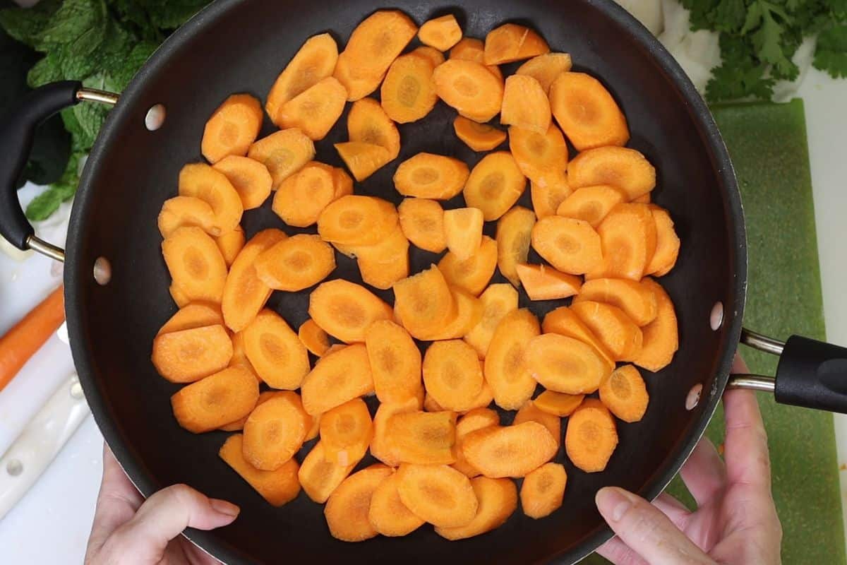 peel and slice the carrots then put in a pan to saute/steam