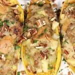 bird's eye view of a serving platter with roasted delicata squash with sausage stuffing
