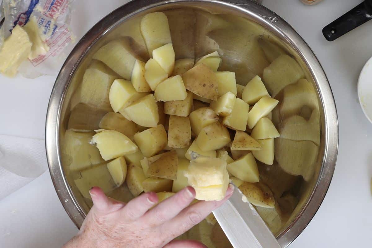 add a chunk of butter to the hot potatoes and mix