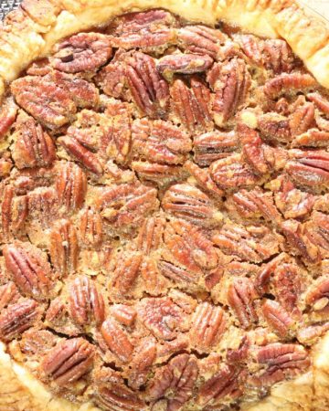 bourbon pecan pie with butter crust in the sun before cutting into it