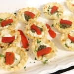 holiday appetizers phyllo cups five ways goat cheese pesto and roasted red pepper on a serving tray and garnished with parsley