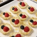 holiday appetizers phyllo cups five ways mascarpone raspberry blueberry bites on a serving tray with drizzled honey