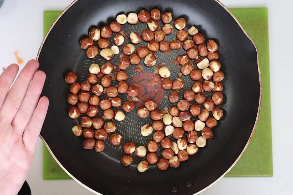 small pan with hazelnuts that will be toasted for 5 minutes