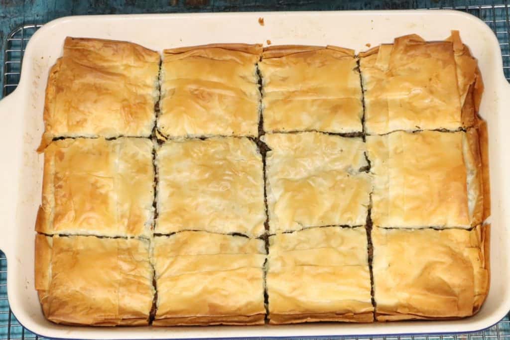 overhead view of moroccan-spiced phyllo meat pie still in 9x13 baking dish