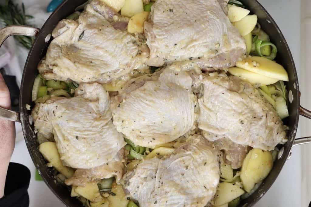 Dijon Chicken with Apples, Leeks and Fennel: place marinated chicken on top of apples and nestle chicken into the veggies and apples