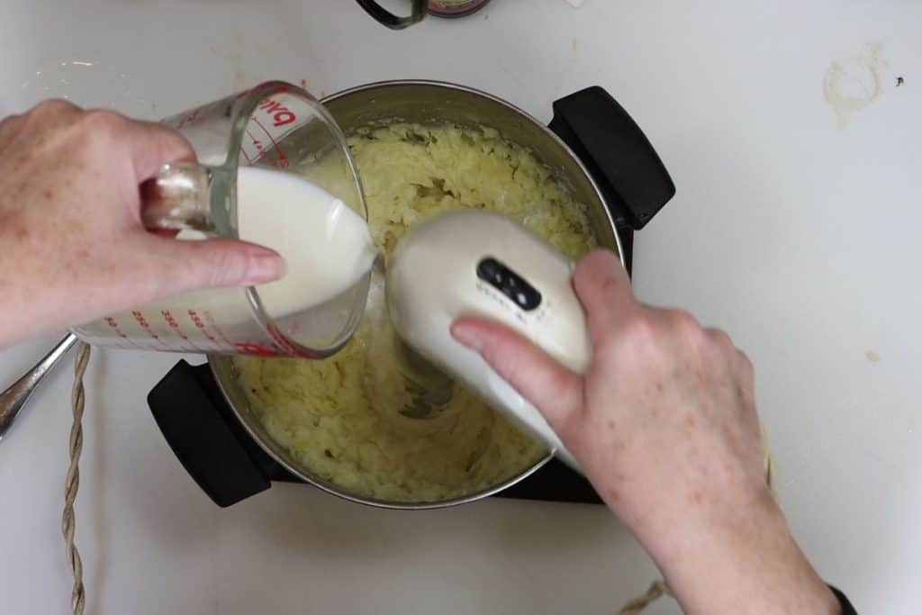 add butter, salt, pepper and warm milk to your drained and cooked potatoes. Mix with a hand blender