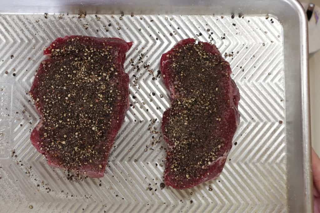 season the filet mignon with salt and a coarse pepper crust on the top