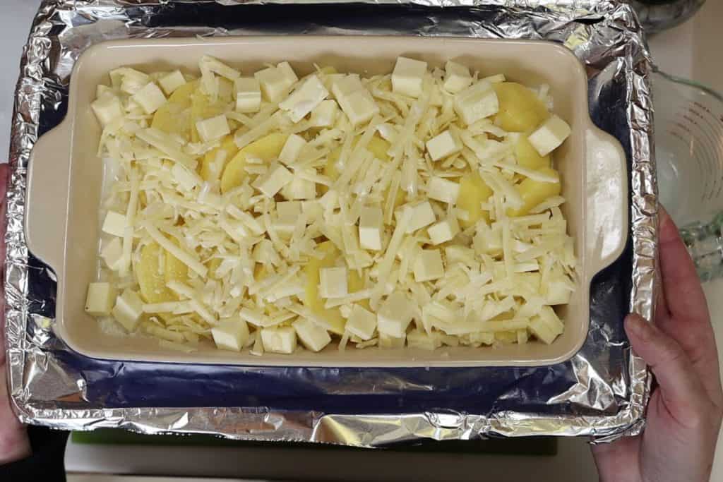 add cheeses and milk to the potatoes and bake in the oven