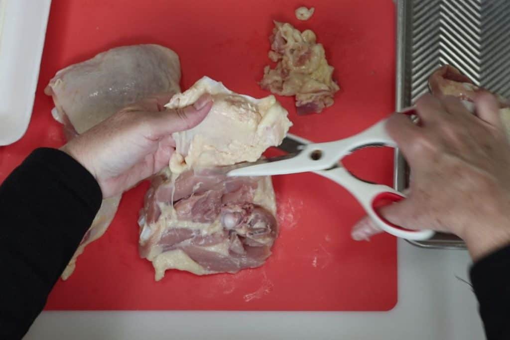 how to trim the fat from chicken thighs: start by trimming obvious flaps of fat