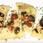Tasty Homemade Pizza Dough with Chicken, Pesto, Fontina & Tomatoes: four slices of both kinds of pizza on a platter