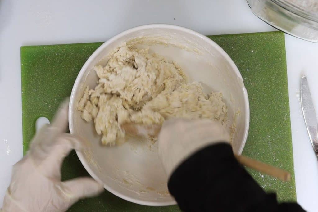 Tasty Homemade Pizza Dough with Chicken, Pesto, Fontina & Tomatoes: mix dough with a spoon until it gets shaggy like this