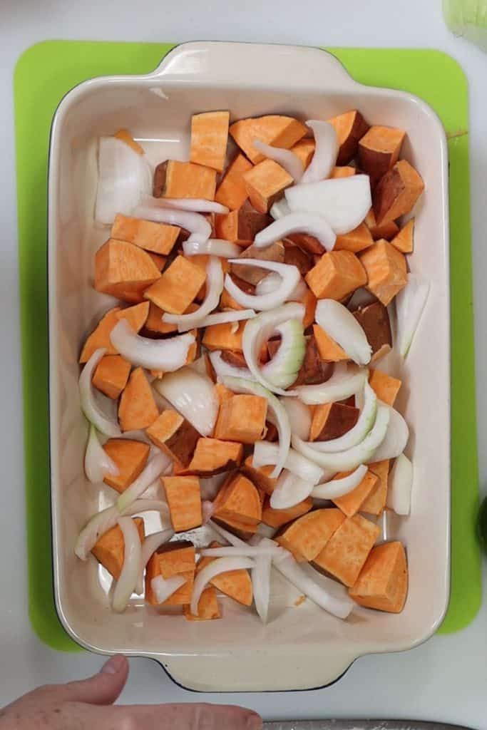 chopped sweet potatoes and onions in a 9x13 baking dish