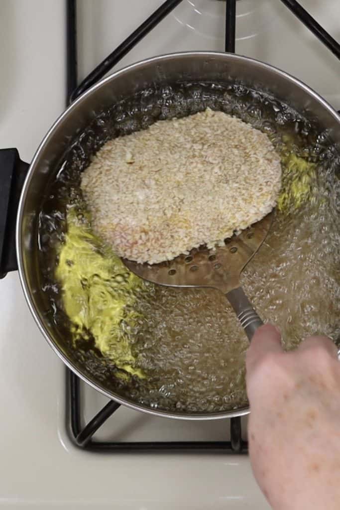 dinner for two ground chicken kiev: gently placing the stuffed and breaded chicken into the hot oil