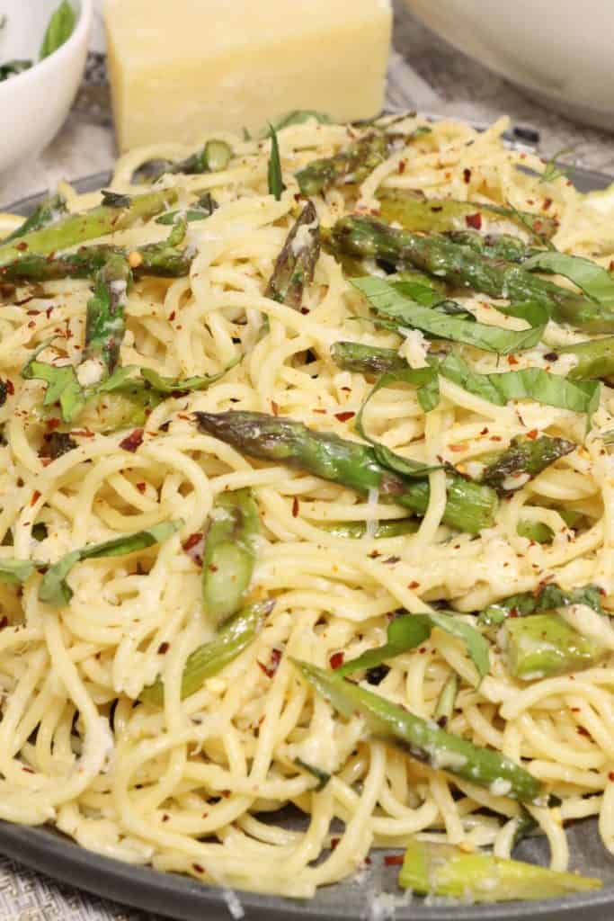 lemony spaghetti with asparagus and basil: side view of serving platter of pasta