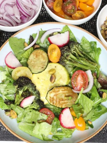 overhead view of summer salad with roasted veggies and garlic scape vinaigrette