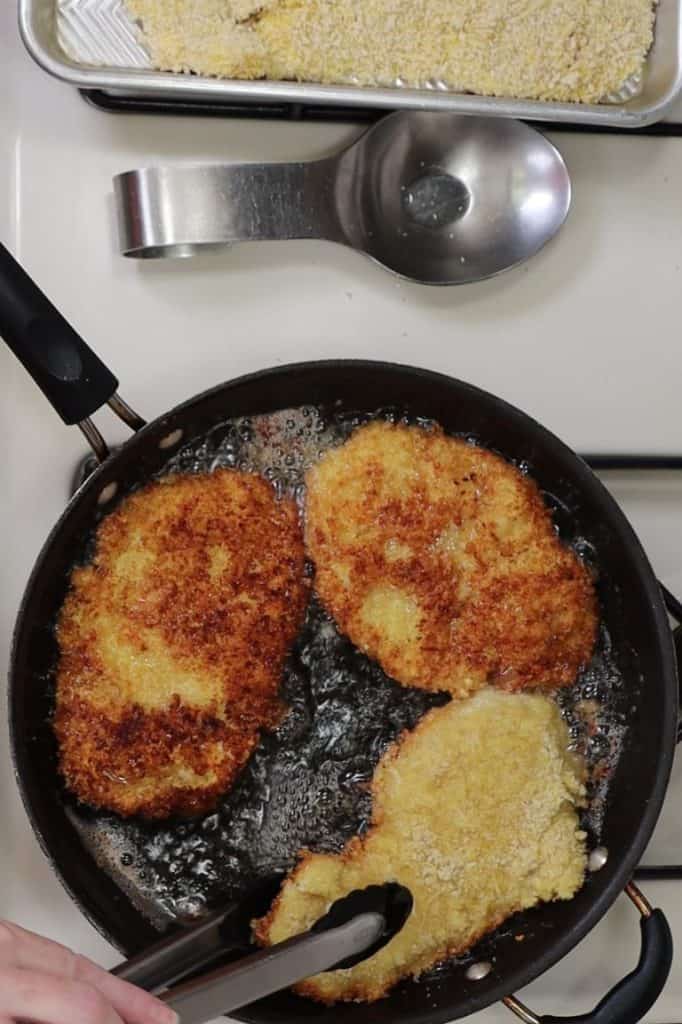 frying the chicken cutlets in canola oil until golden brown