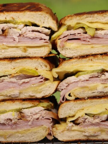 easy pressed cuban sandwiches stacked on top of each other