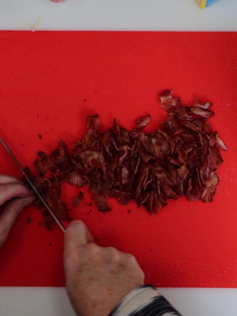 chopping cooked bacon into small pieces