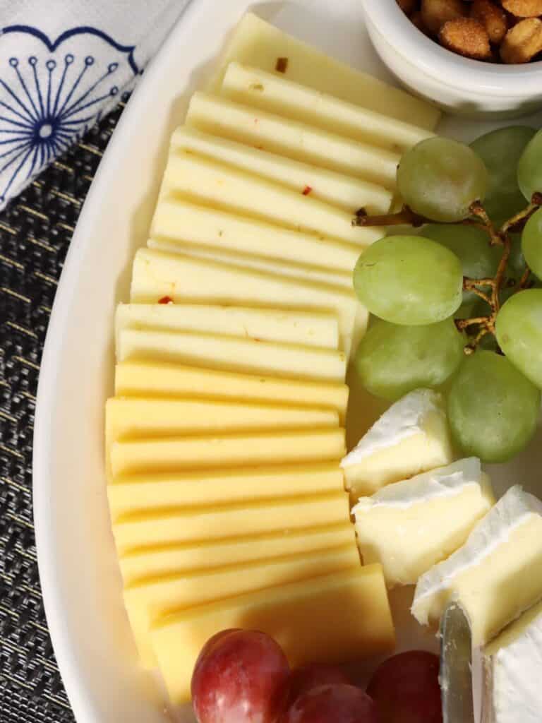 affordable walmart cheese tray symmetrical slices of gouda and pepperjack, grapes, and brie