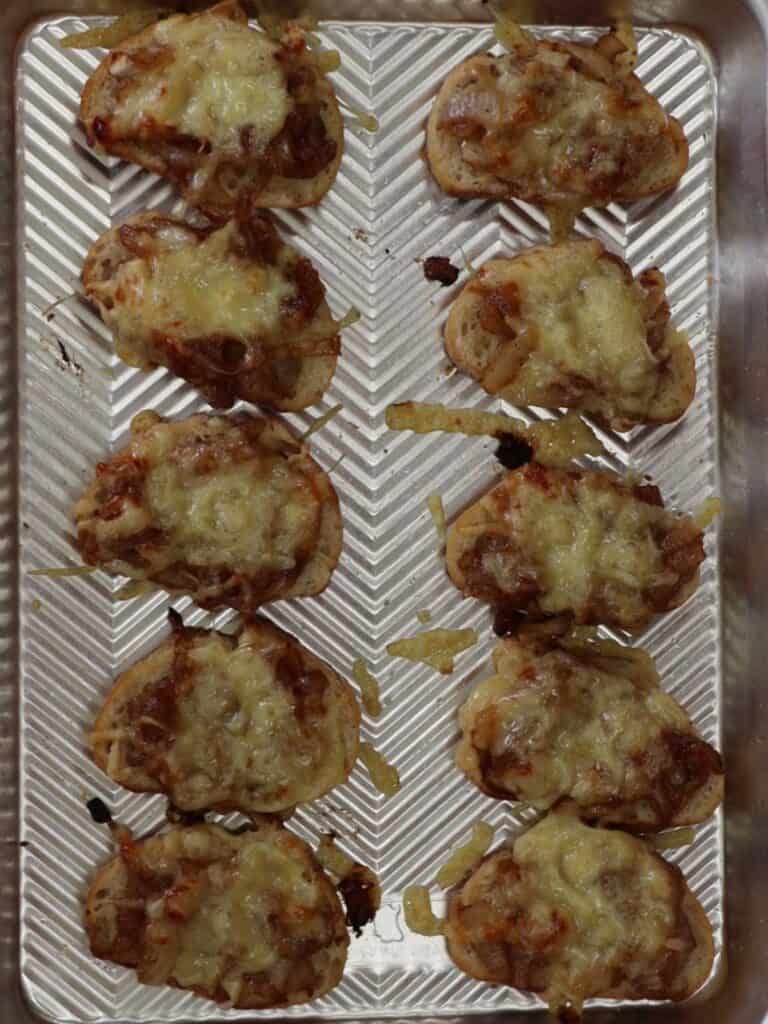 french onion soup crostini on a sheet pan right out of the oven