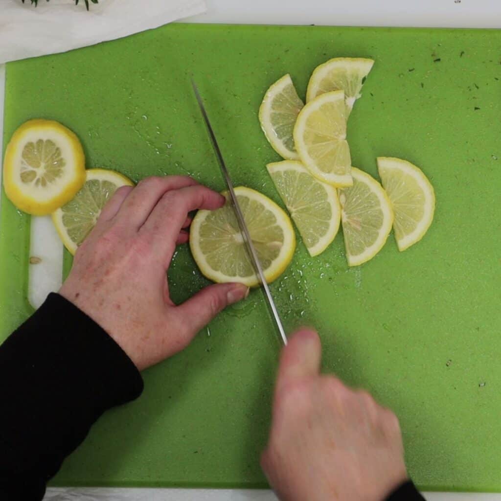 cutting lemon slices in half