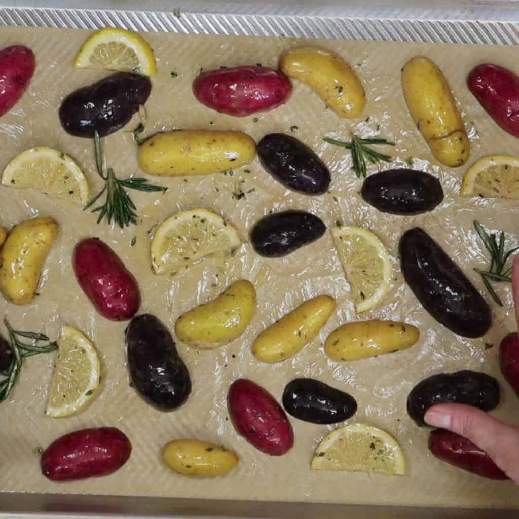 for lemony herby roasted fingerlings spread the ingredients out on a sheet pan
