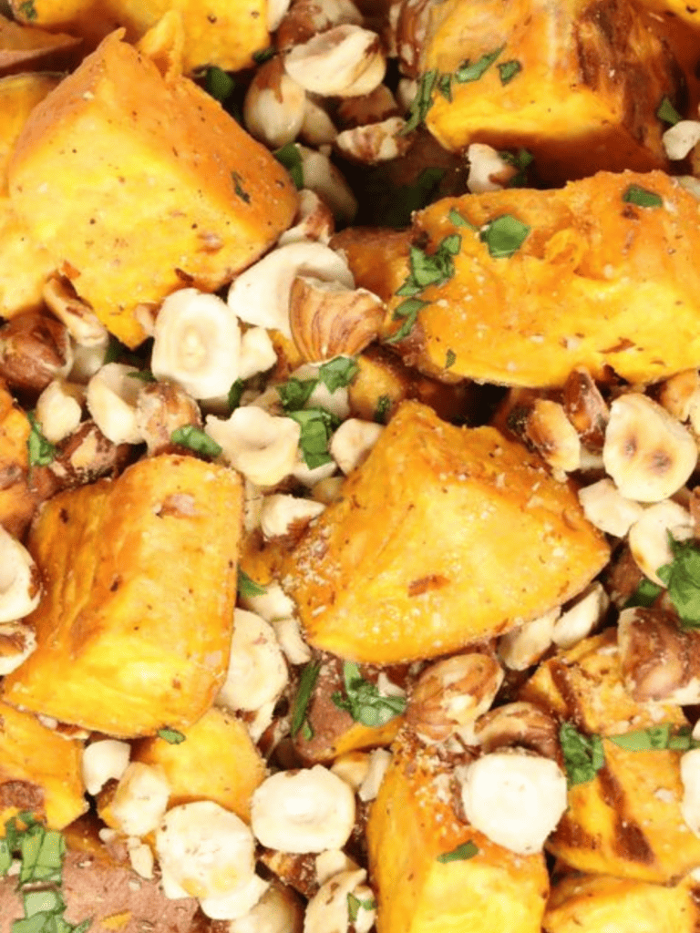 roasted sweet potatoes and hazelnuts in serving bowl with parsley
